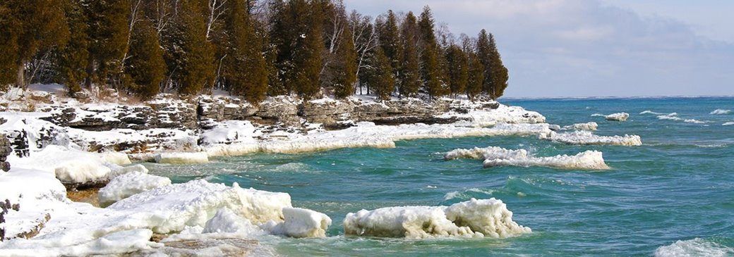 The snow-covered shoreline at the lake