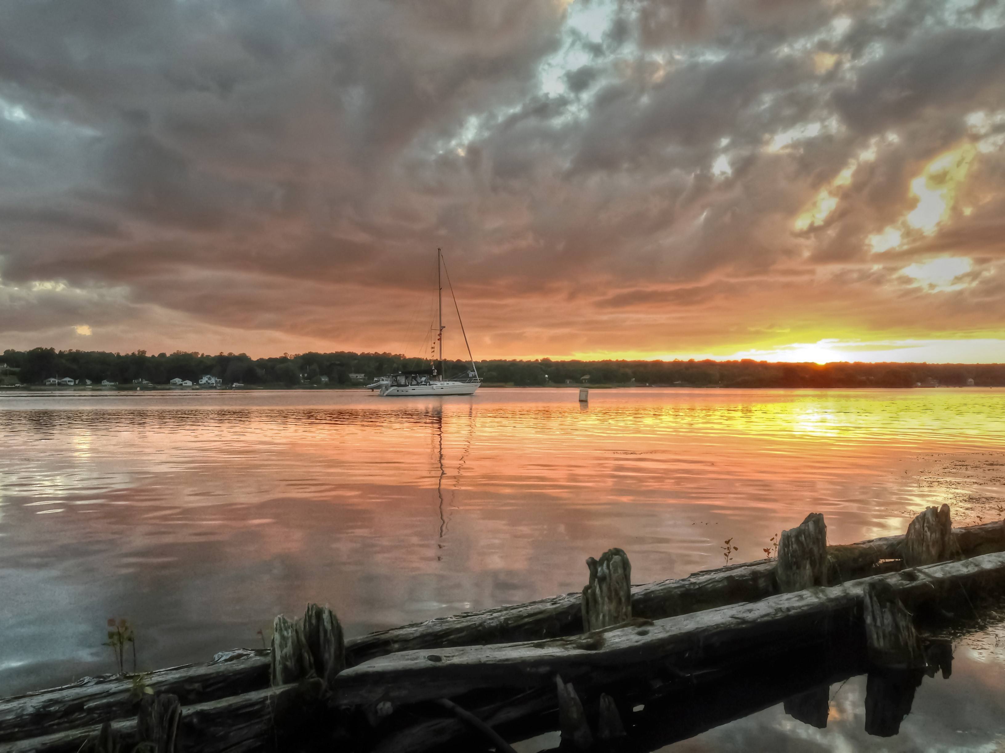 A sailboat on the lake at sunset.