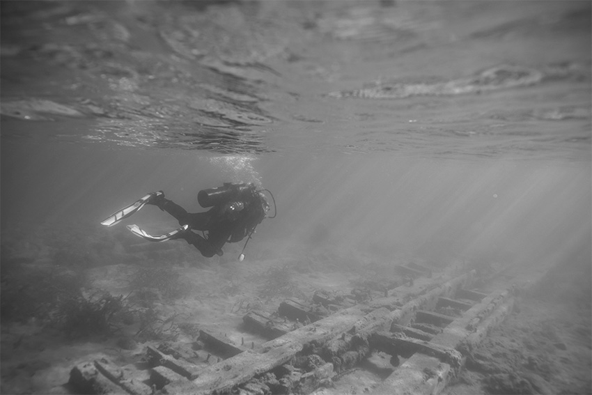 A diver explores a shipwreck deep under the surface of Lake Michigan.
