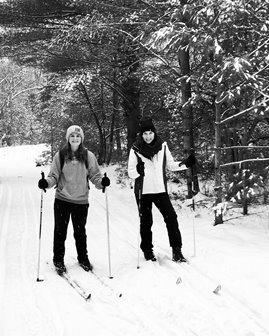 Two women cross-country skiing.