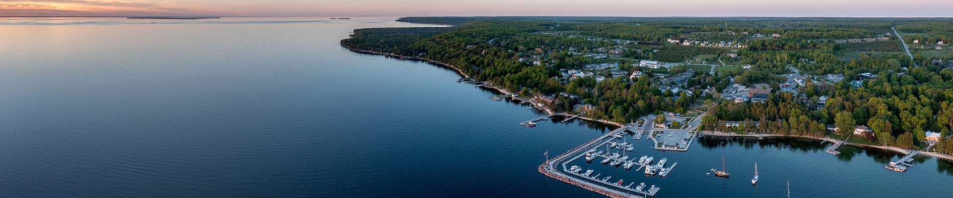 An aerial view of a lakeside community at sunset.