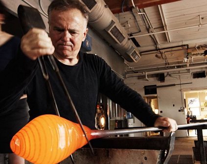 A man blowing glass.