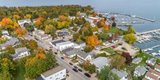 A town and marina surrounded by trees in their fall colors