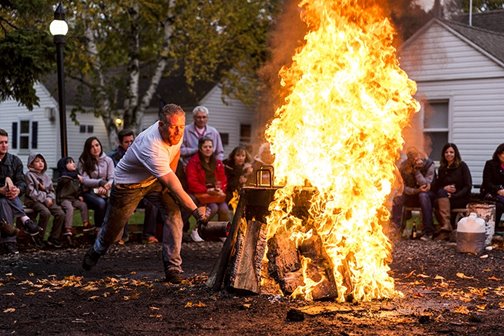 People sitting around a bonfire.