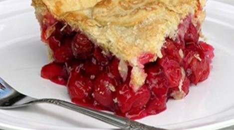 A closeup of a slice of cherry pie