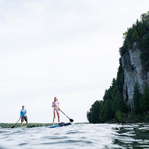 Two people standup paddle boarding
