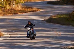 A motorcycle driving down a winding road