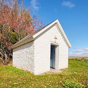 A small white stone chapel.