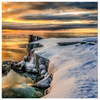 The snow-covered lake shore.