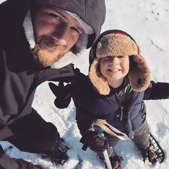 A dad and son cross country skiing