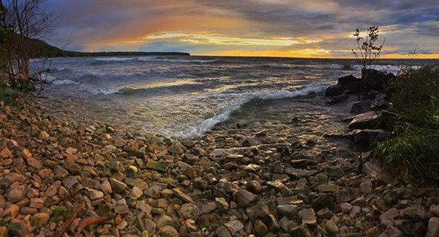 A rocky beach at sunset