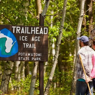 Couple looking at an Ice Age Trailhead sign.